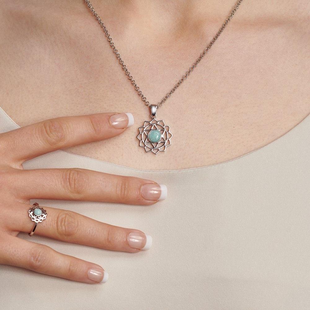 Woman wearing a silver Heart Chakra Necklace and Heart Chakra Ring